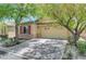 Well-maintained one-story home with two-car garage, attractive desert landscaping, and mature shade trees at 5916 Sorto Lago St, North Las Vegas, NV 89081