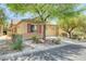 Lovely single-story home boasts desert landscaping, mature trees, an attached two-car garage, and great curb appeal at 5916 Sorto Lago St, North Las Vegas, NV 89081