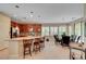 Bright kitchen features an island with granite counters, stainless steel appliances, and a connected dining area at 5916 Sorto Lago St, North Las Vegas, NV 89081