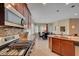 The kitchen area has an eat-in island and stainless steel appliances at 5916 Sorto Lago St, North Las Vegas, NV 89081