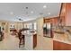 Open kitchen featuring an eat-in island, stainless steel appliances, and an adjoining living room at 5916 Sorto Lago St, North Las Vegas, NV 89081
