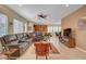Open living room featuring tile floors, a comfortable sectional sofa, and views into the modern kitchen and dining area at 5916 Sorto Lago St, North Las Vegas, NV 89081
