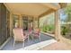 Cozy covered patio area featuring outdoor seating and a view of the landscaped backyard at 5916 Sorto Lago St, North Las Vegas, NV 89081
