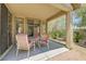 Cozy covered patio area featuring outdoor seating and a view of the landscaped backyard at 5916 Sorto Lago St, North Las Vegas, NV 89081