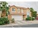 Two-story home with neutral paint, a two-car garage, desert landscaping, and mature palm trees at 6007 Turtle River Ave, Las Vegas, NV 89156