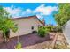 Backyard view featuring neutral stucco, red tile roof and desert landscaping at 6035 Shadow Oak Dr, North Las Vegas, NV 89031