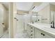 Modern bathroom with double sinks, white cabinets, and a glass-enclosed shower at 6035 Shadow Oak Dr, North Las Vegas, NV 89031