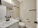 Bathroom with bronze fixtures, white vanity, tile surround in shower and modern toilet at 6035 Shadow Oak Dr, North Las Vegas, NV 89031