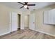 Bedroom with wood-look floors, closet with sliding doors, and natural light at 6035 Shadow Oak Dr, North Las Vegas, NV 89031