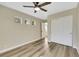 Bedroom with wood-look floors, view to hallway and double-door closet at 6035 Shadow Oak Dr, North Las Vegas, NV 89031