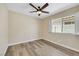 Bedroom featuring wood-look floors, neutral walls, and window with bright natural light at 6035 Shadow Oak Dr, North Las Vegas, NV 89031