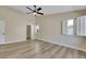 Large bedroom with wood-look floors, large windows, and a walk-in closet at 6035 Shadow Oak Dr, North Las Vegas, NV 89031