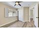 Bedroom featuring wood-look floors, closet with sliding doors, and views of exterior at 6035 Shadow Oak Dr, North Las Vegas, NV 89031