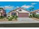 Charming single-story home showcasing a well-manicured front yard and a two-car garage at 6035 Shadow Oak Dr, North Las Vegas, NV 89031