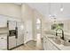 Updated kitchen with white cabinets, stainless refrigerator, and a breakfast bar at 6035 Shadow Oak Dr, North Las Vegas, NV 89031
