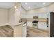 Well-lit kitchen with stainless steel appliances, white cabinets, and wood-look floors at 6035 Shadow Oak Dr, North Las Vegas, NV 89031