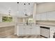 Well-lit kitchen features white cabinets, stainless steel appliances, and breakfast bar at 6035 Shadow Oak Dr, North Las Vegas, NV 89031