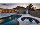 Inviting backyard pool and hot tub area, surrounded by landscaping, creating a relaxing outdoor oasis at 6213 Fairwood Ave, Las Vegas, NV 89107