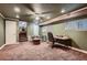 Finished basement featuring carpeted floors, drop ceiling, and a seating area for a functional living space at 6213 Fairwood Ave, Las Vegas, NV 89107