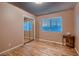 Bedroom featuring hardwood flooring, closet with mirrored doors, and window with blind at 6213 Fairwood Ave, Las Vegas, NV 89107