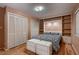 Bedroom with hardwood flooring, built in shelves, and 2 double door closets at 6213 Fairwood Ave, Las Vegas, NV 89107