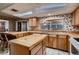 Functional kitchen layout with ample counter space, light cabinetry, and a breakfast bar at 6213 Fairwood Ave, Las Vegas, NV 89107
