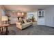 Spacious living room with plush carpeting, comfortable seating, and an open floor plan at 6213 Fairwood Ave, Las Vegas, NV 89107