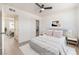 Cozy bedroom with ceiling fan, bedside tables, and view to living room and walk-in closet at 6444 Bannock Way, Las Vegas, NV 89107