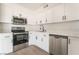 Modern kitchen featuring white cabinets, stainless steel appliances, and light countertops at 6444 Bannock Way, Las Vegas, NV 89107