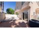 Backyard with concrete and wood patio, sliding glass door, block wall, and palm trees at 6459 Rusticated Stone Ave # 103, Henderson, NV 89011
