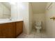 Cozy bathroom featuring a single sink vanity, tiled flooring and updated toilet at 6459 Rusticated Stone Ave # 103, Henderson, NV 89011