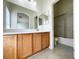 Bathroom with double vanity, mirrors, and bathtub with shower at 6459 Rusticated Stone Ave # 103, Henderson, NV 89011