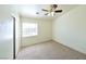 Comfortable bedroom with carpet flooring, ceiling fan, and natural light from a window at 6459 Rusticated Stone Ave # 103, Henderson, NV 89011