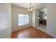 A naturally lit dining room featuring laminate flooring and a hanging chandelier at 6459 Rusticated Stone Ave # 103, Henderson, NV 89011