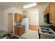 Well-lit kitchen with oak cabinets, neutral counters, and modern appliances at 6459 Rusticated Stone Ave # 103, Henderson, NV 89011