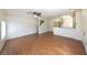 Open-concept living area with wood floors, ceiling fan, and natural light at 6459 Rusticated Stone Ave # 103, Henderson, NV 89011