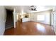 Open-concept living area with wood floors, stairway, and kitchen access at 6459 Rusticated Stone Ave # 103, Henderson, NV 89011