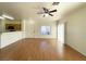 Bright living area with wood floors, ceiling fan, and access to the kitchen at 6459 Rusticated Stone Ave # 103, Henderson, NV 89011