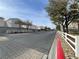 Community street with sidewalks and uniform white fences, showing a peaceful neighborhood at 6459 Rusticated Stone Ave # 103, Henderson, NV 89011