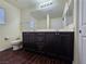 Bathroom with dark wood cabinets, double sinks, and a large mirror at 6824 Briarwood Bend Ave, Las Vegas, NV 89130