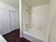 Bathroom featuring shower/tub combo, dark floors and double doors at 6824 Briarwood Bend Ave, Las Vegas, NV 89130