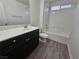 Bathroom featuring vanity, toilet and tub/shower combo with white tile at 6824 Briarwood Bend Ave, Las Vegas, NV 89130