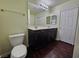 Bathroom featuring vanity, toilet, and dark wood-look floors at 6824 Briarwood Bend Ave, Las Vegas, NV 89130