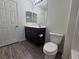 Bathroom with dark wood cabinet and modern toilet at 6824 Briarwood Bend Ave, Las Vegas, NV 89130