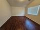 Bedroom with dark wood floors, white walls, and natural light from a window at 6824 Briarwood Bend Ave, Las Vegas, NV 89130