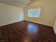 Cozy bedroom featuring dark wood floors and a window for natural light at 6824 Briarwood Bend Ave, Las Vegas, NV 89130