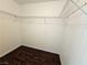 Walk-in closet features wire shelving and dark wood-look flooring at 6824 Briarwood Bend Ave, Las Vegas, NV 89130
