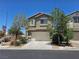 Two-story home with desert landscaping, a two car garage and a well-maintained, neutral colored exterior at 6824 Briarwood Bend Ave, Las Vegas, NV 89130