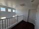 Bright, airy hallway featuring modern railing, natural light, and dark wood floors at 6824 Briarwood Bend Ave, Las Vegas, NV 89130