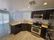 Charming kitchen with stainless steel appliances and hardwood-style flooring at 6824 Briarwood Bend Ave, Las Vegas, NV 89130